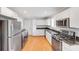 Modern kitchen featuring stainless steel appliances, granite counters, and white cabinetry at 2001 Tyvola Rd, Charlotte, NC 28210