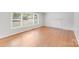 Bright living room features hardwood flooring, large windows, and a fireplace mantle at 2001 Tyvola Rd, Charlotte, NC 28210