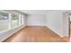 Bright living room featuring large windows, hardwood floors, and a fireplace mantle at 2001 Tyvola Rd, Charlotte, NC 28210