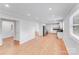 Spacious living area with hardwood floors seamlessly connecting to the kitchen and laundry area at 2001 Tyvola Rd, Charlotte, NC 28210