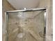 Elegant tiled shower with glass door and built-in bench at 2001 Tyvola Rd, Charlotte, NC 28210