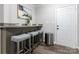 Cozy bar area featuring barstool seating, modern decor, and a convenient access to a back door at 2012 Double Oaks Rd, Charlotte, NC 28206