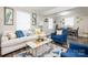 Bright living room with elegant furnishings, a marble coffee table, and a seamless flow into the dining area at 2012 Double Oaks Rd, Charlotte, NC 28206