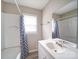 Bathroom with a modern vanity, bathtub with curtain, neutral wall color, and light colored flooring at 2123 W Sixth Ave, Gastonia, NC 28052