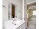 Bright bathroom featuring a modern vanity with a sleek mirror, white countertop, and an open doorway to the living area at 2123 W Sixth Ave, Gastonia, NC 28052