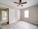 Cozy bedroom features neutral walls, a ceiling fan, a window for natural light, and wood-look flooring at 2123 W Sixth Ave, Gastonia, NC 28052