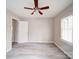 Bedroom featuring neutral walls, ceiling fan, a window for natural light, and wood-look flooring at 2123 W Sixth Ave, Gastonia, NC 28052