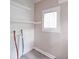 Cozy laundry room with shelving, utility connections, a window and light-colored flooring at 2123 W Sixth Ave, Gastonia, NC 28052