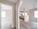 Bright living room flows into the kitchen area, featuring light gray walls and modern light wood-look flooring at 2123 W Sixth Ave, Gastonia, NC 28052