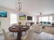 Open-concept living and dining area with modern furniture, a large TV, and bright windows provide a stylish and inviting space at 2123 W Sixth Ave, Gastonia, NC 28052