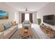 Bright living room with a large window, comfortable seating, modern furniture, and a green houseplant at 2123 W Sixth Ave, Gastonia, NC 28052