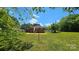 Expansive backyard with lush green grass and mature trees creating a serene outdoor space at 2203 Arney St, Lincolnton, NC 28092