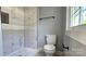 Contemporary bathroom features a tiled shower with niche and modern black fixtures at 2203 Arney St, Lincolnton, NC 28092