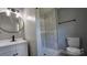 Modern bathroom with a tiled shower, stylish vanity, round mirror and contemporary fixtures at 2203 Arney St, Lincolnton, NC 28092