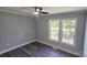 Comfortable bedroom featuring two windows for natural light, neutral paint, and a ceiling fan at 2203 Arney St, Lincolnton, NC 28092