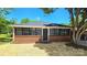 Charming brick home featuring a black roof and black framed windows and newly laid straw in the front yard at 2203 Arney St, Lincolnton, NC 28092