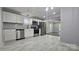 Modern kitchen with stainless steel appliances, white cabinets, mosaic backsplash and white tile floor at 2203 Arney St, Lincolnton, NC 28092