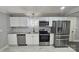 Modern kitchen featuring stainless steel appliances, white cabinets, and mosaic backsplash at 2203 Arney St, Lincolnton, NC 28092