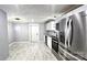 Well-lit kitchen featuring stainless steel appliances, white cabinets and countertops, and modern light fixtures at 2203 Arney St, Lincolnton, NC 28092