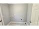 Functional laundry room with grey paint and tile flooring at 2203 Arney St, Lincolnton, NC 28092
