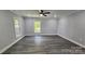 Spacious main bedroom featuring modern gray walls, wood-look floors, crown molding, and natural light at 2203 Arney St, Lincolnton, NC 28092