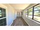 Bright sunroom with wood-look flooring, beadboard walls, and an abundance of windows at 2203 Arney St, Lincolnton, NC 28092
