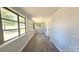Bright sunroom with wood-look flooring, beadboard walls, and many windows at 2203 Arney St, Lincolnton, NC 28092