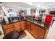 Wet bar area featuring granite countertop, wood cabinetry and stocked with liquor bottles at 2580 Penngate Dr, Sherrills Ford, NC 28673