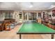 Basement entertainment area featuring ping pong, a sofa, bar area, and an exterior door at 2580 Penngate Dr, Sherrills Ford, NC 28673