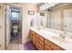 Bathroom with a double sink vanity with marble countertop, framed mirrors and access to a toilet room at 2580 Penngate Dr, Sherrills Ford, NC 28673