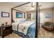Comfortable bedroom with a four-poster bed, neutral walls, and a ceiling fan for a relaxing atmosphere at 2580 Penngate Dr, Sherrills Ford, NC 28673