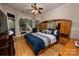 Bedroom featuring hardwood floors, a large window seat, and a full mirrored wall surrounding the headboard at 2580 Penngate Dr, Sherrills Ford, NC 28673