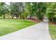 Long, paved driveway leading to a home through a lush green lawn and mature trees at 2580 Penngate Dr, Sherrills Ford, NC 28673