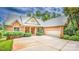 Inviting brick home featuring a well-manicured front yard and a convenient attached two-car garage at 2580 Penngate Dr, Sherrills Ford, NC 28673