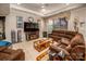 Spacious living room featuring tray ceiling, large sectional sofa, and natural light from a picture window at 2580 Penngate Dr, Sherrills Ford, NC 28673