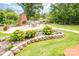 Outdoor patio features a brick fireplace, outdoor seating, and stone-lined flower beds at 2580 Penngate Dr, Sherrills Ford, NC 28673