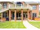 Covered brick patio with seating, grill, and hot tub, ideal for relaxing and outdoor enjoyment at 2580 Penngate Dr, Sherrills Ford, NC 28673