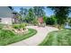 A paved patio features an outdoor dining set, brick fireplace, and landscaped flower beds, with lake views at 2580 Penngate Dr, Sherrills Ford, NC 28673