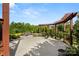Spacious backyard with a concrete patio, pergola, lush greenery, and a wooded backdrop at 2830 Berkhamstead Cir, Concord, NC 28027