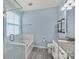 Bathroom featuring a glass-enclosed shower, a soaking tub, and a stylish vanity with a granite countertop at 2830 Berkhamstead Cir, Concord, NC 28027