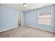 Bedroom with neutral carpeting, a window for natural light, and a door leading to the closet at 2830 Berkhamstead Cir, Concord, NC 28027