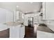 Modern kitchen with white cabinets, stainless steel appliances, and a spacious island at 2830 Berkhamstead Cir, Concord, NC 28027