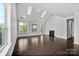 Bright living room featuring hardwood floors, skylights, and fireplace creating inviting space at 2830 Berkhamstead Cir, Concord, NC 28027