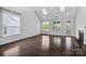 Sunlit living room with hardwood floors, fireplace, and skylights creating a warm ambiance at 2830 Berkhamstead Cir, Concord, NC 28027