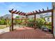 Backyard featuring a wood pergola and lush landscaping for a relaxed outdoor experience at 2830 Berkhamstead Cir, Concord, NC 28027