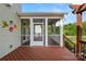 Rear view of a screened porch with an exterior door and steps leading into the yard at 2830 Berkhamstead Cir, Concord, NC 28027