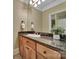 Bathroom with granite countertops, wooden cabinets, and a large mirror at 298 Horton Grove Rd, Fort Mill, SC 29715