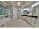 Luxurious bathroom with chandelier, double sink vanity, tub, and elegant tile flooring at 298 Horton Grove Rd, Fort Mill, SC 29715