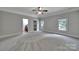 Spacious primary bedroom featuring plush carpet, natural light, and a walk-in closet at 298 Horton Grove Rd, Fort Mill, SC 29715