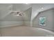 Bedroom features neutral carpeting, a ceiling fan, and natural light from a window at 298 Horton Grove Rd, Fort Mill, SC 29715
